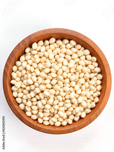 Lot of whole unpeeled sesame seeds in wooden bowl flatlay isolated on white background