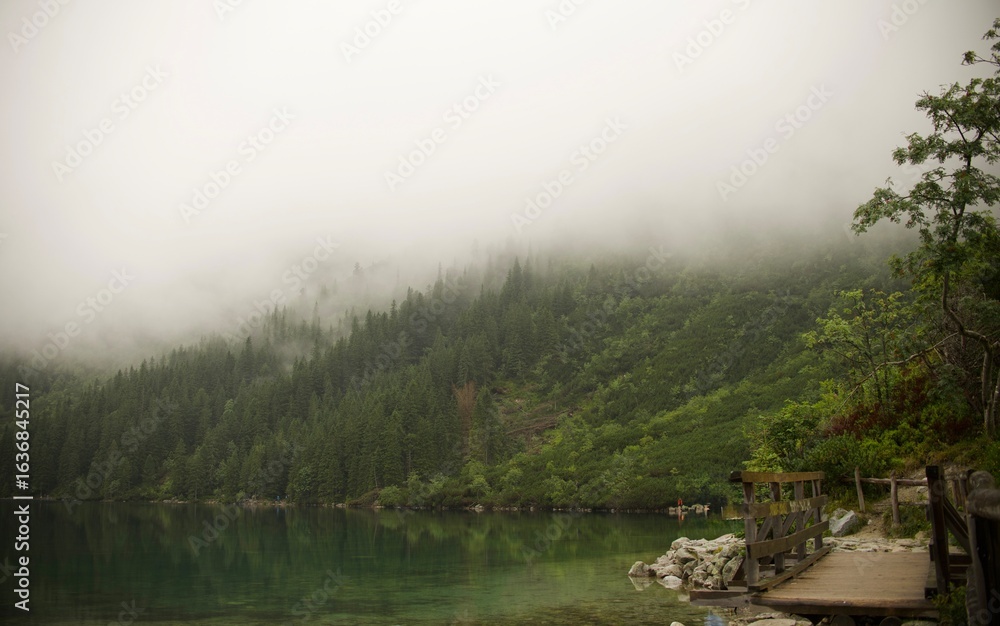 Fototapeta premium Misty morning on the lake in mountains
