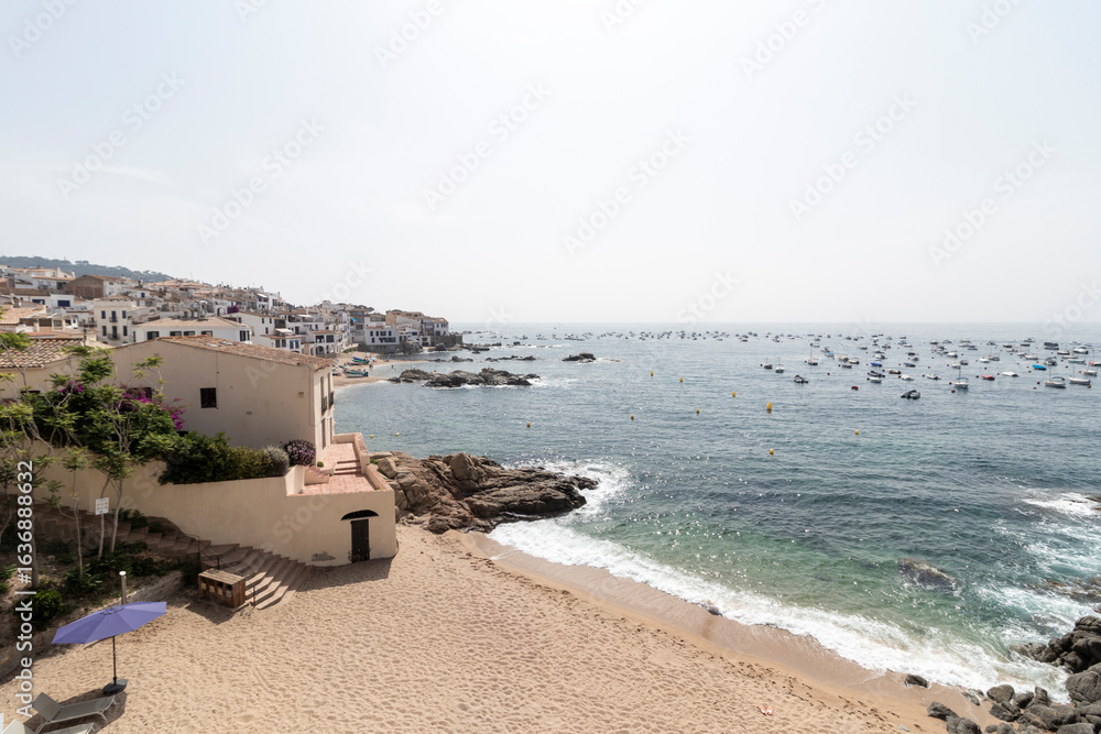 Obraz premium Calella de palafrugell beach and boats on sunny day in spain
