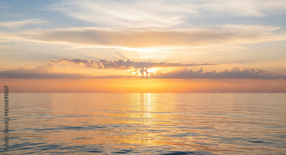 Obraz premium A generic background with soft sunlight breaking through clouds over a calm ocean, left blank for adding an inspirational or religious quote, conveying hope and reflection