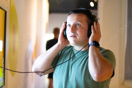 Man Engaged in Audio Experience at Exhibition