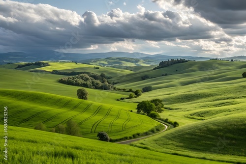 Rolling green hills and valleys under a dramatic cloudy sky