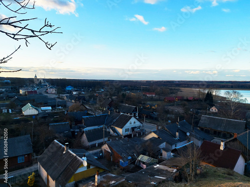 Wallpaper Mural Scenic view of a quiet village at dusk overlooking the river in early spring Torontodigital.ca