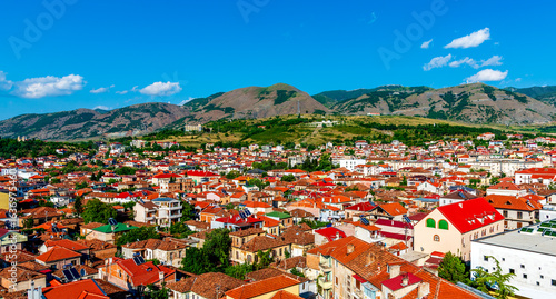 Panoramic View of Korça, Albania with Red-Tiled Roofs and Mountain Backdrop
