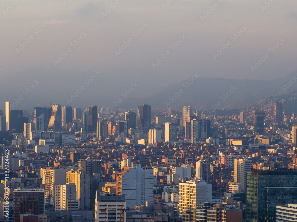 Fototapeta premium Sunset view of high-rise buildings in Miraflores, Lima, Peru, highlighting dense urban architecture with vertical structures and countless windows.