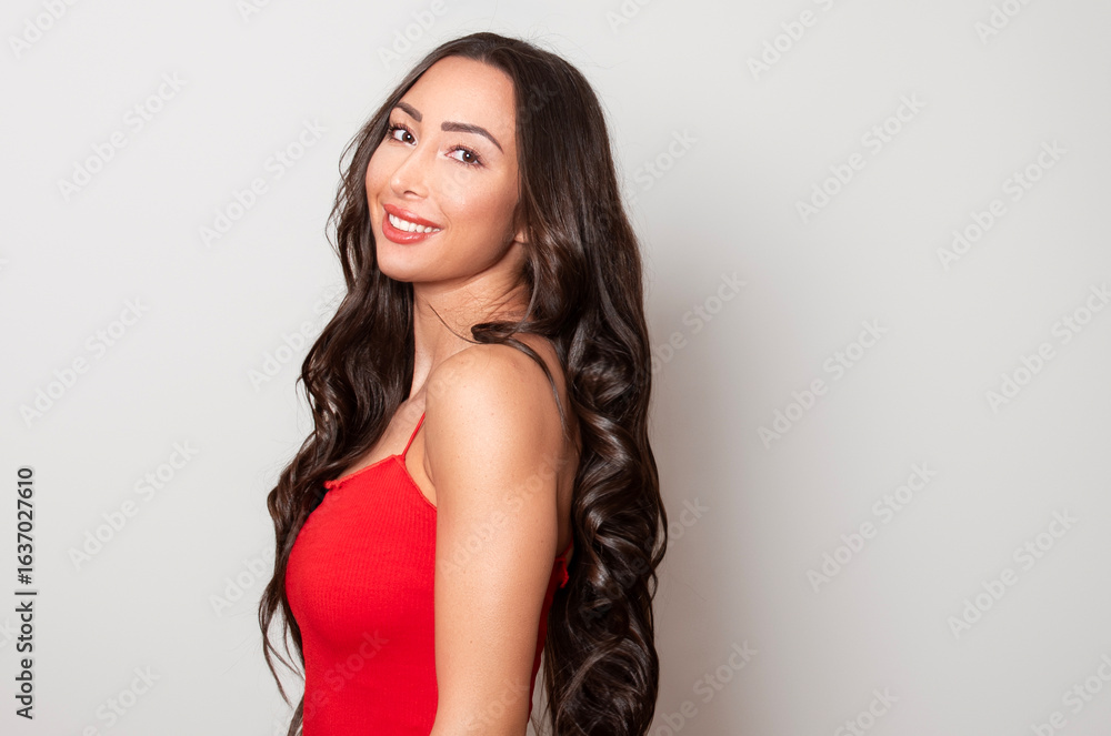 Fototapeta premium Beautiful young woman with long black shiny hair 