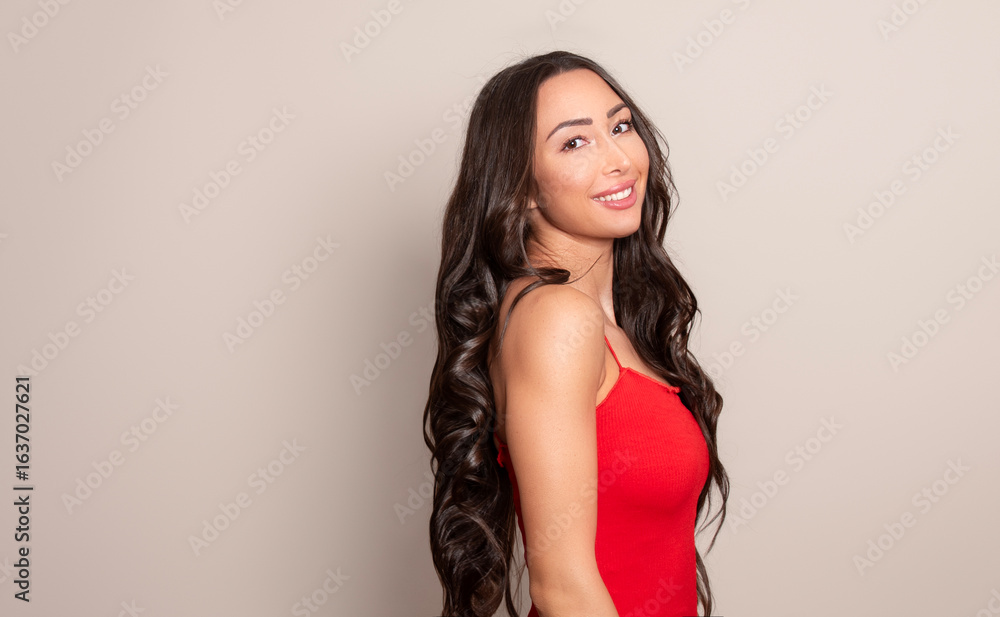 Fototapeta premium Beautiful young woman with long black shiny hair 