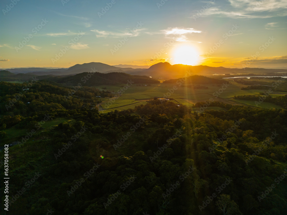 Fototapeta premium Aerial Sunset Over North Queensland Mountains and Farmland – Scenic Farmland Landscape, Misty Afternoon Light, Tropical Rural Beauty, Nature Photography, Australian Countryside, Farming Aerial View