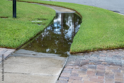 Severe Drainage Issue on a Sidewalk as Water from a heavy rain Has Created a large puddle