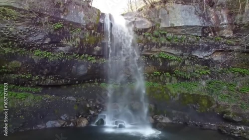 Cascading Waterfall Flowing Over Moss Covered Rock Formation Beauty