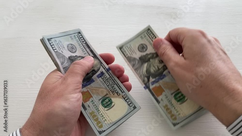 man counting money 100 US dollar bills, symbol for business or wealth