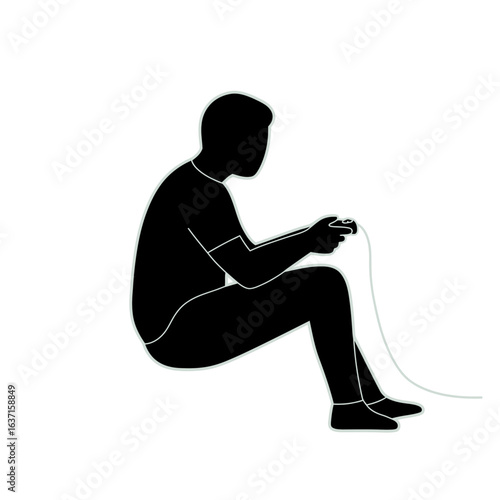 Silhouette of a person sitting on the floor, focused on playing a video game with a wired controller.