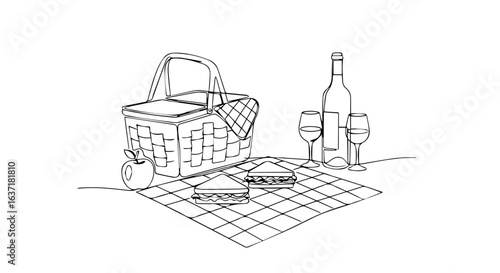 Romantic picnic basket with wine bottle and sandwiches on checkered blanket. Elegant picnic setup includes wicker basket, wine glasses, apple, and delicious sandwiches for romantic outdoor lunch.