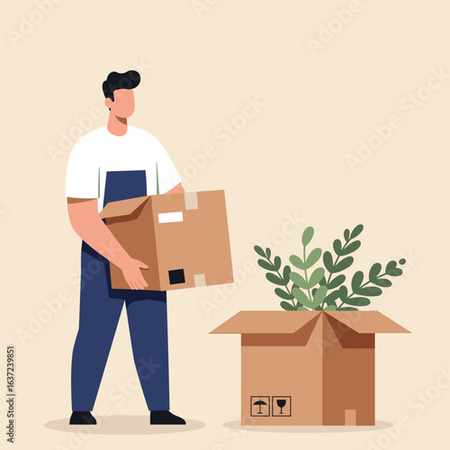 Man holding moving box while unpacking a plant indoors  