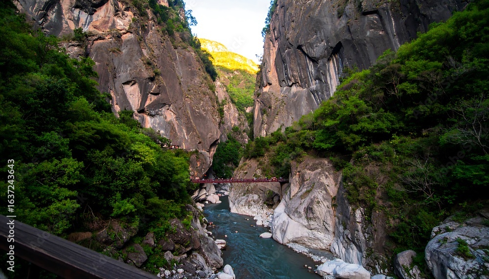 Steep canyon walls meet a flowing river Steep canyon walls meet a flowing river