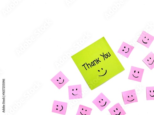 Thank you message on green note paper isolated on white background with smile emoji, Copy space 