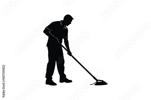 Silhouette of a man sweeping