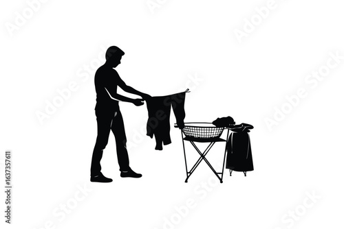 Silhouette of a man folding laundry on a folding ironing board