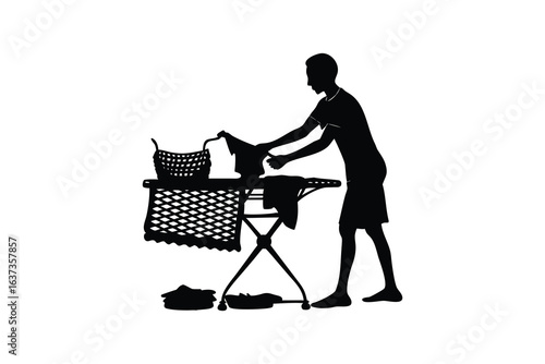 Silhouette of a man folding laundry on a folding ironing board