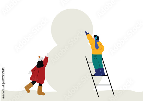 大きな雪だるまを作る子供達