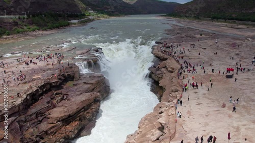 Drone view of Hukou Waterfall in Shanxi Province, China, it is a magnificent sight of the surging Yellow River water, filled with energy and awe inspiring，4k slow motion footage aerial view.