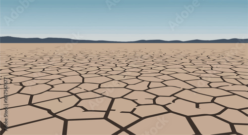 Cracked arid soil stretches out towards dark hills under a clear blue sky