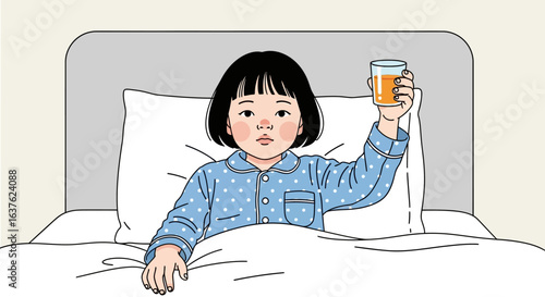 Young girl in bed holding up a glass of orange juice, wearing blue polka dot pajamas.