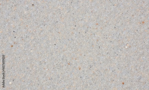 Close-up of light gray decorative concrete surface with speckles and a smooth finish.