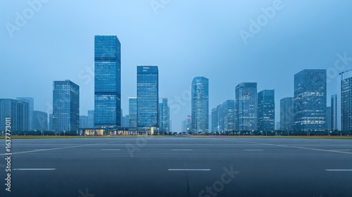 Cityscape at Dusk: Modern Architecture and Urban Landscape with Empty Road in Foreground