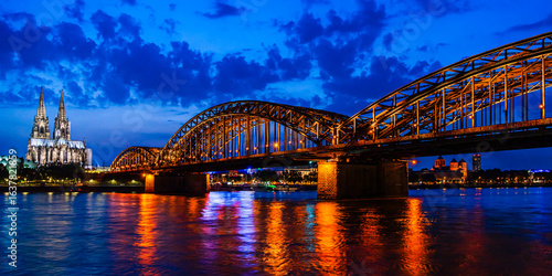 Beautiful night landscape of the Cologne, Germany with gothic cathedral, Hohenzollern Bridge and reflections over the River Rhine