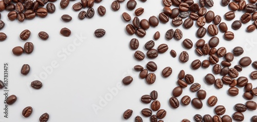 Dark brown coffee beans scattered on light gray background, close-up shot showing rich textures,  pile,  grain