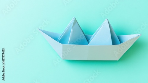 Wallpaper Mural Paper boat sailing on a serene sea of light blue, symbolizing dreams and journeys Torontodigital.ca