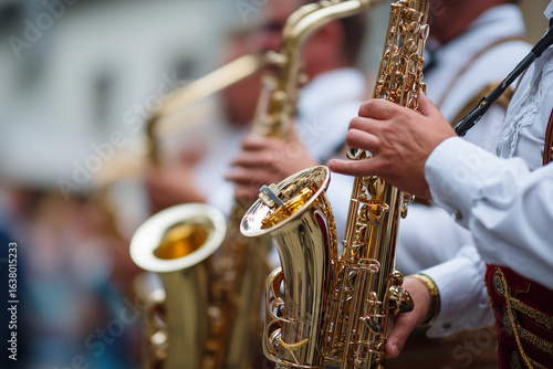 Traditional brass band performing on stage at Oktoberfest, close-up of instruments and costumes, 
