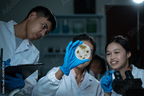 Multidisciplinary science students work in a modern lab analyzing microbial samples to support research in biology chemistry health and other scientific fields