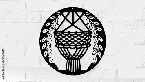 Black and white macrame plant hanger with leaves in a circle on a brick wall background design art silhouette