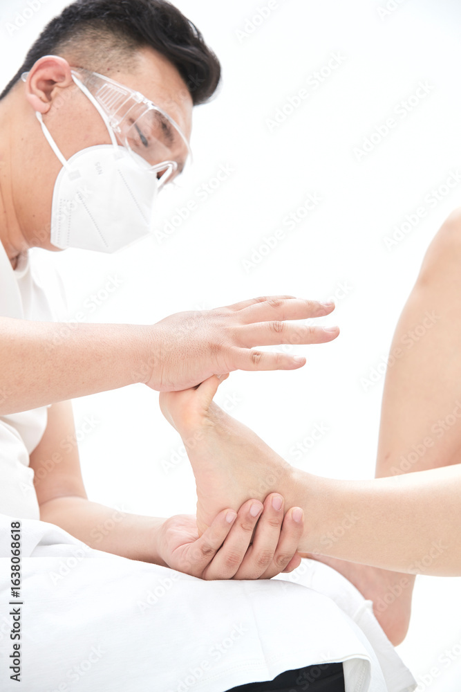 Fototapeta premium Doctor performs a breast examination on a patient undergoing breast augmentation.