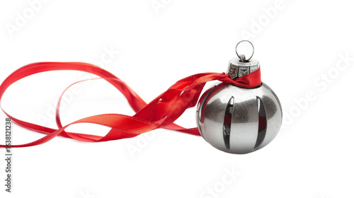 A shiny silver Christmas ornament with a red ribbon, elegantly placed on a white background, ready for holiday decoration, evoking festive spirit and seasonal joy