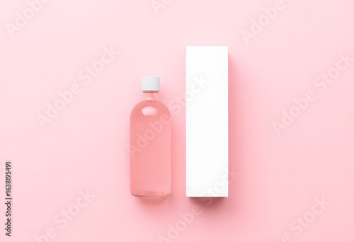 Pink Cosmetic Bottle with Box on Pastel Background