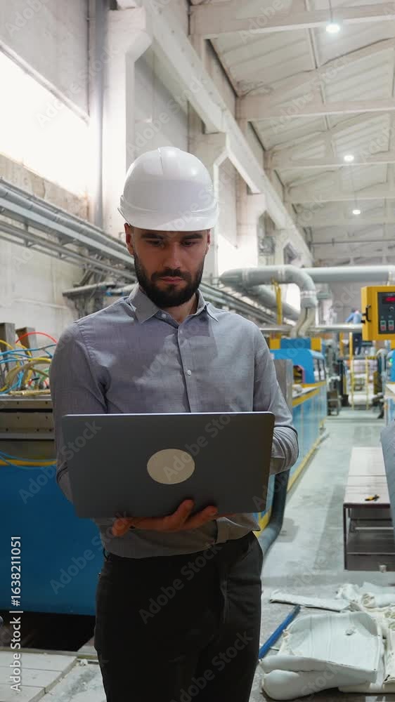 Industrial engineer using laptop and managing production line Industrial engineer using laptop and managing production line