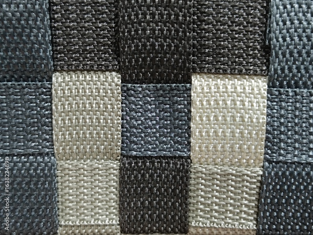 Fototapeta premium Close-Up of Woven Plastic Texture in Black, Gray, and Beige Checker Pattern
