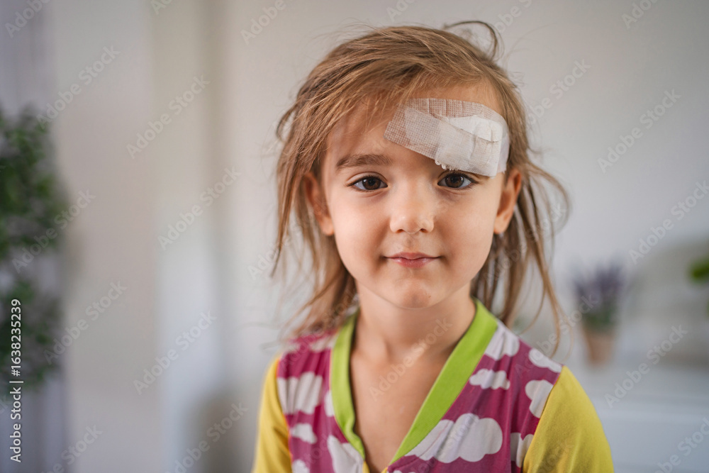 Little Girl with Bandage on Forehead Recovering at Home Little Girl with Bandage on Forehead Recovering at Home