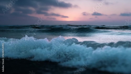 Serene Ocean Waves at Dawn. The dawn's soft hues paint the sky as ocean waves crash, creating a captivating display of natural beauty and tranquility.