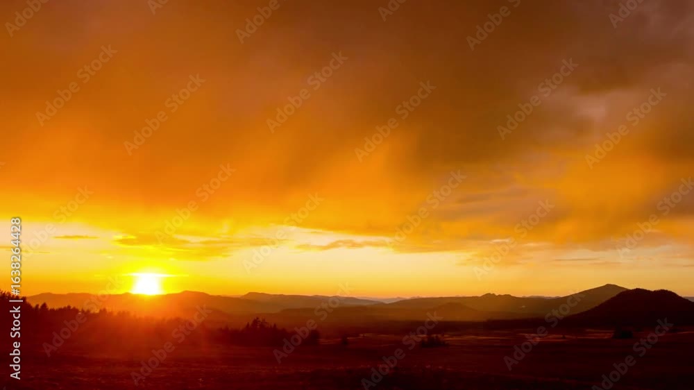 A beautiful sunset with a golden sky and mountains in the background A beautiful sunset with a golden sky and mountains in the background