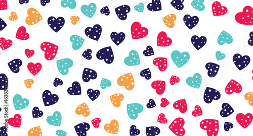 Vibrant polka-dotted hearts of red, blue, teal, and orange are scattered across a clean white background, creating a playful and cheerful seamless pattern design.