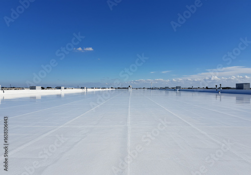 White Reflective Industrial Building Roof Surface Under Blue Sky Heatwave