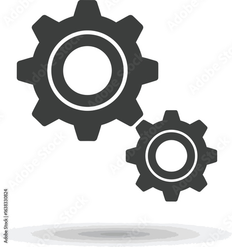 Two dark grey gears, one large and one small, interlocked and casting a shadow on a white background, symbolizing teamwork and industry
