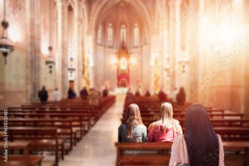 Blurred photo inside of a church - People praying in a church