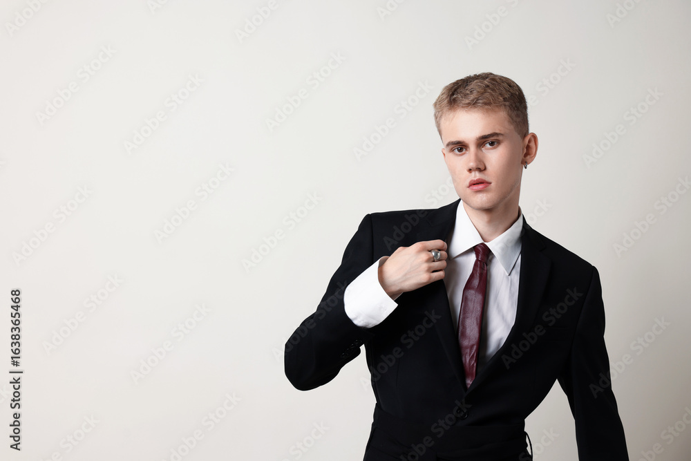Handsome young man wearing stylish suit on white background, space for text Handsome young man wearing stylish suit on white background, space for text