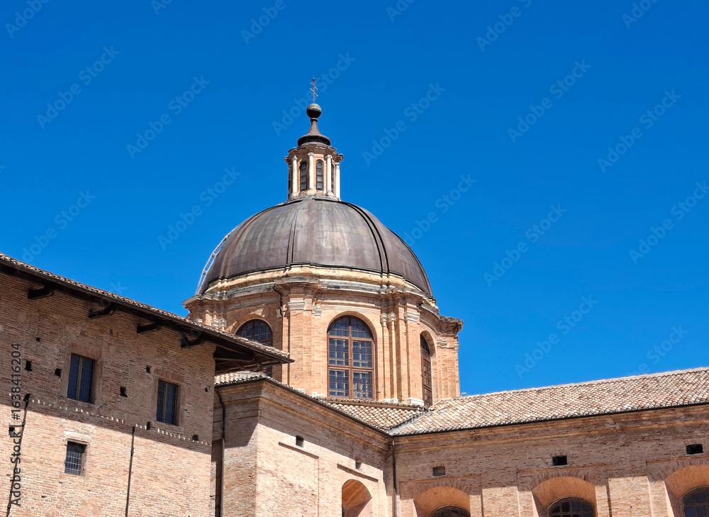Fototapeta premium sunny dome of the famous Urbino cathedral against the blue sky