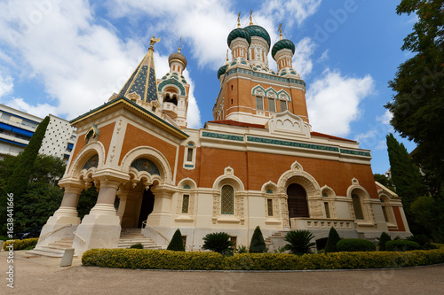 Daytime view of St. Nicholas Orthodox Cathedral in Nice  France  . Stunning Russian Revival architecture surrounded by trees  captured in natural daylight .